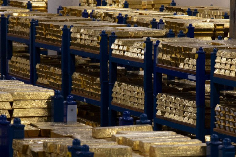 Gold bars stored in secure vaults across the world